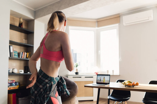 Woman dancing home following video lessons on laptop - Φωτογραφία, εικόνα
