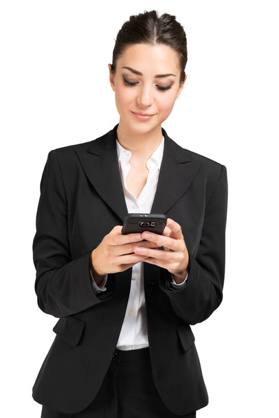Businesswoman using a mobile phone isolated on a white background - Photo, Image