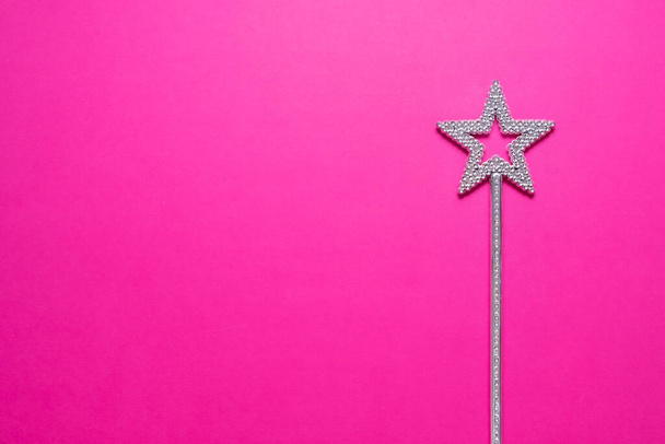 Sparkling magic wand on a pink background. Concept of celebration and magic, copy space. - Photo, Image