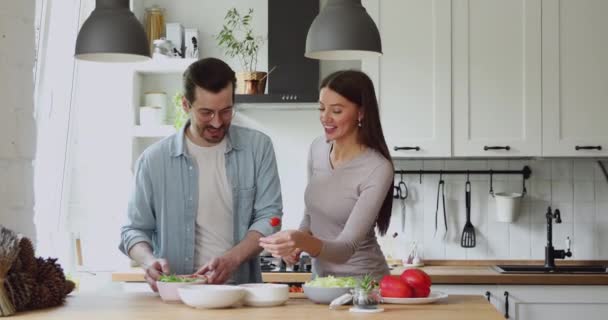 Romantic couple in modern kitchen enjoy conversation and cooking process - Felvétel, videó