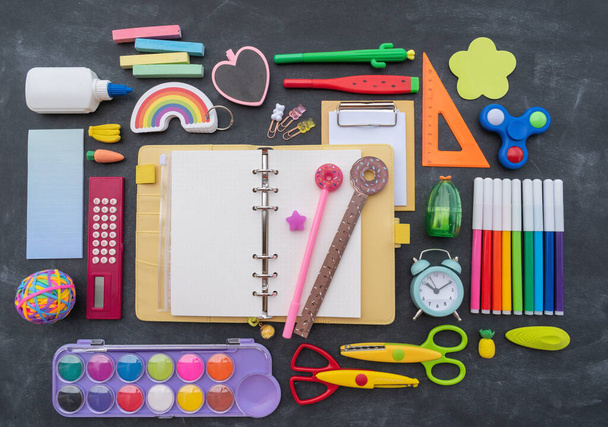 Stationery chalk board. Back to school. Open notepad on top of office supplies. Children kawaii stationery for school. Flat lay - Fotoğraf, Görsel