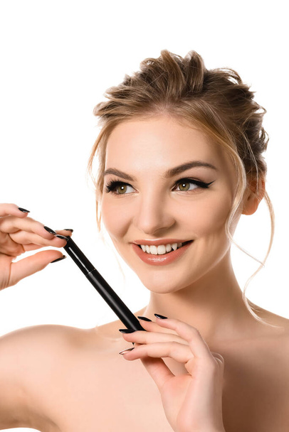 smiling naked beautiful blonde woman with makeup and black nails holding mascara isolated on white - Φωτογραφία, εικόνα