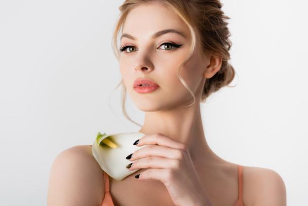 elegant beautiful blonde woman holding calla flower on shoulder isolated on white - Zdjęcie, obraz