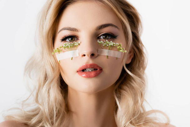 beautiful blonde woman with wildflowers under eyes isolated on white - Φωτογραφία, εικόνα