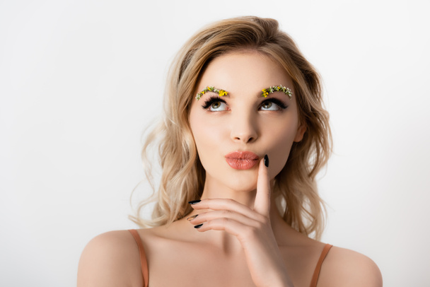 dreamy beautiful blonde woman with wildflowers on eyebrows isolated on white - Fotografie, Obrázek