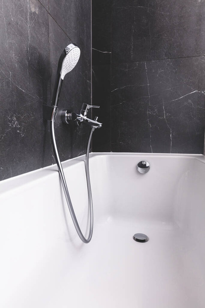 Bath and shower in modern new luxury bathroom. Interior design in black and white style - Fotografie, Obrázek