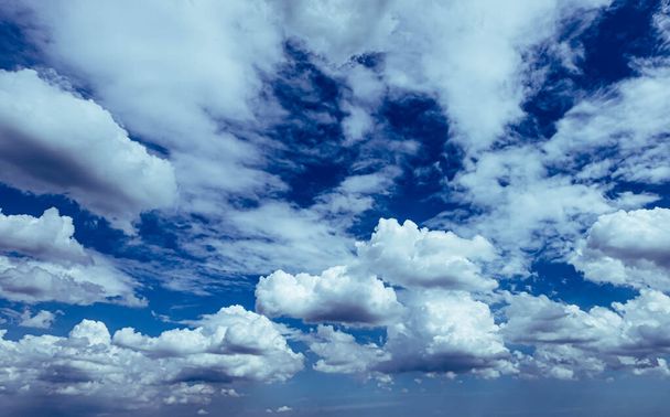 Blue sky white fluffy clouds background. Beautiful blue sky and white cumulus clouds abstract background. Cloudscape background. Blue sky and fluffy white clouds on sunny. - Zdjęcie, obraz