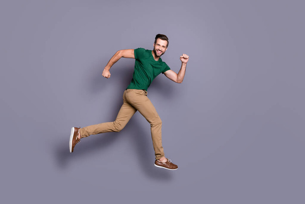 Full length profile side photo of excited guy jump run after spring season time discount wear good look clothes footwear isolated over gray color background - Φωτογραφία, εικόνα