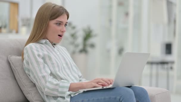 Excited Young Woman Celebrating Success on Laptop at Home  - Záběry, video