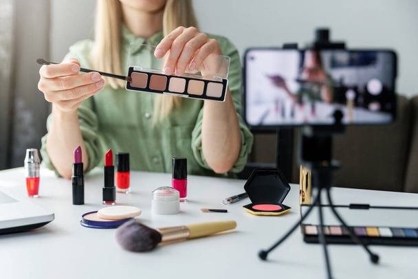 makeup beauty fashion blogger influencer recording video presenting cosmetics on social media at home - Photo, Image