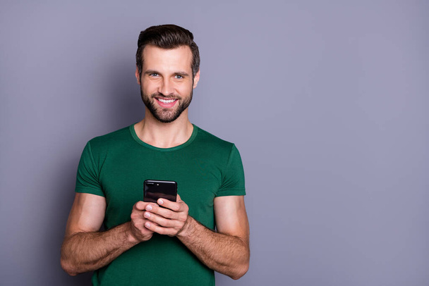 Portrait of charming satisfied imposing guy use cellphone enjoy online social media texting typing post comment repost wear good look outfit isolated over gray color background - Foto, Imagem
