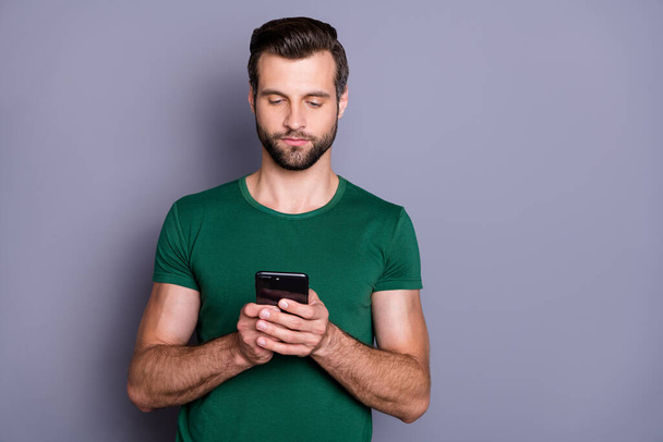 Portrait of minded focused guy use smartphone repost share social network information wear good look outfit isolated over gray color background - Foto, Bild
