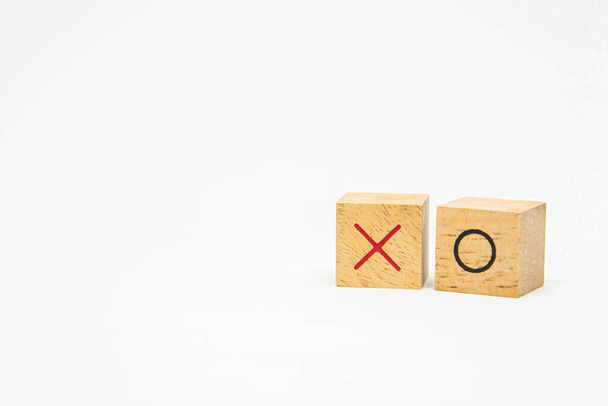 Wooden square block with O and X character symbol isolated on white background for design concept - 写真・画像
