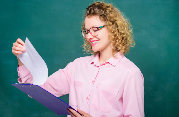 Doing research. teacher with document folder. happy student in glasses at blackboard. girl teacher at school lesson. new school year. Girl prepare for exams. report project. back to school - Photo, Image