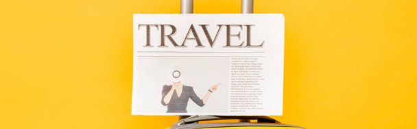 travel newspaper on colorful suitcase on yellow background, panoramic shot - Φωτογραφία, εικόνα