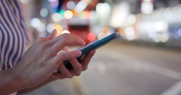 Femme utilisation du téléphone portable dans la rue la nuit - Photo, image