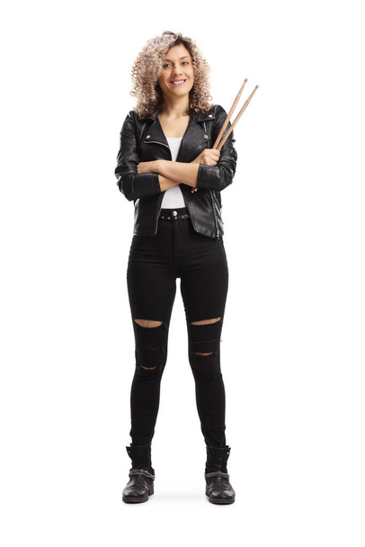 Full length portrait of a rock female drummer holding drumsticks isolated on white background - Photo, Image