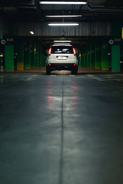 λευκό SUV αυτοκίνητο στο υπόγειο πάρκινγκ. αστικός τρόπος ζωής. αντίγραφο χώρου - Φωτογραφία, εικόνα