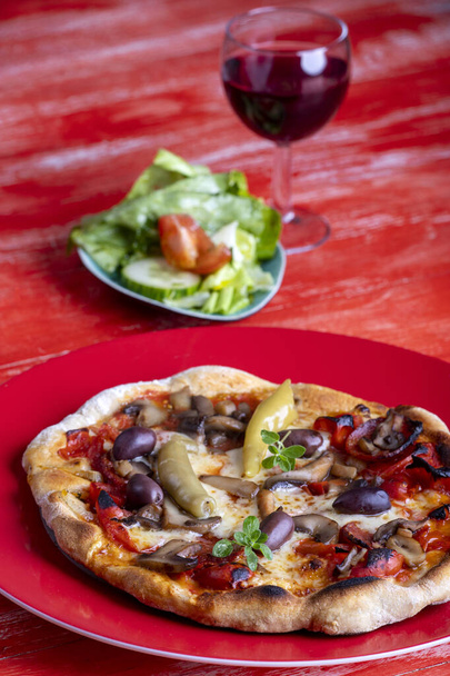 fresh pizza on a red background - Фото, зображення