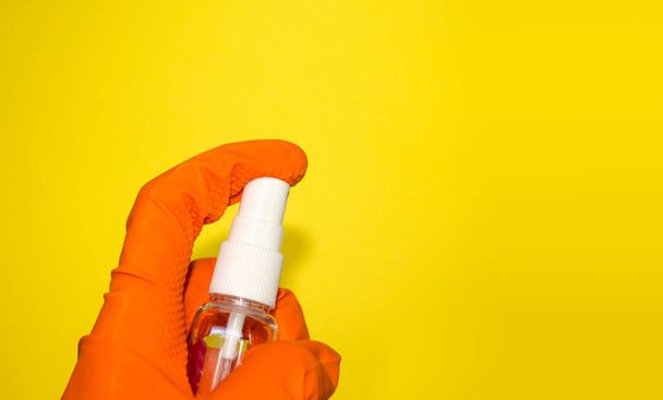 Hand in protective glove holds a disinfectant spray. Sanitize your hands and take care of your health. Self protection during quarantine. Banner with copy space.  - Photo, Image