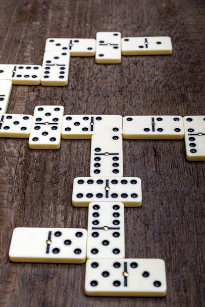Dominoes game on old rustic wooden background. The concept of the game dominoes. High resulotion image. - Fotoğraf, Görsel