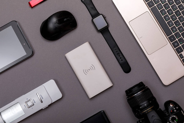 Flat lay of designer workplace. Top view work space photographer with digital camera, smartwatch, memory card, external harddisk, USB card reader and accessory on grey background. - Φωτογραφία, εικόνα