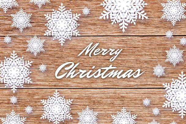 Merry Christmas winter background with snowflakes on wood - Foto, Imagen