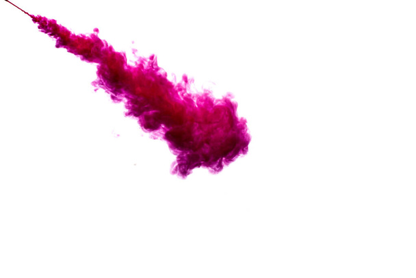 A cloud of red paint is released into the clear water. Isolate on a white background. - Foto, afbeelding