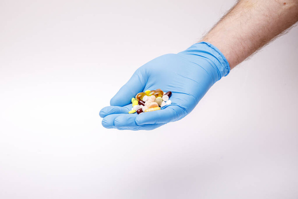Man hold medical flu dose of medicine or treatment drug concept in hand with protective glove. Coronavirus problem and covid-19 protection concept. High resulotion image. - Foto, Imagen