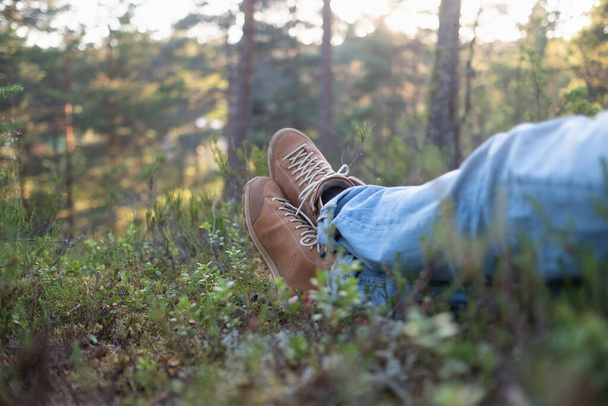 resting on the ground after hiking at autumn forest - Photo, image