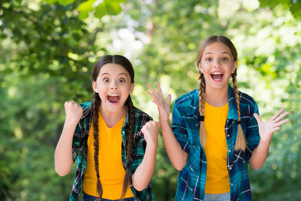 Never give up. small happy girls wear checkered shirt. kid casual fashion. childhood happiness. happy childrens day. spend time and have fun together. best school friends. concept of friendship - Фото, изображение