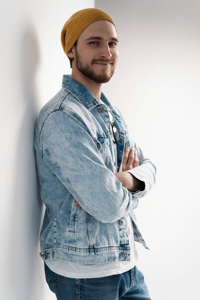 Fashion portrait of young man wearing jeans jacket. - Foto, afbeelding