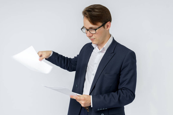 Businessman with scattered papers. Business, people, emotions - businessman throws documents in the office. Business and finance concept. - Valokuva, kuva