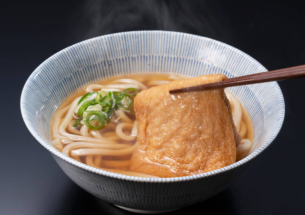 Fideos Udon en una sopa caliente con tofu frito
 - Foto, imagen