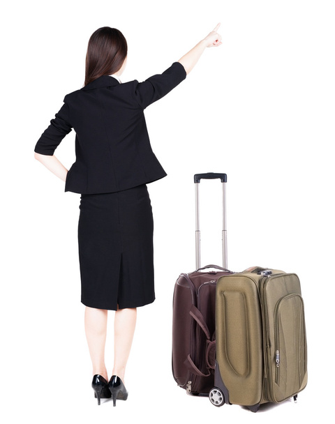Back view of young brunette business woman traveling with suitcase - Zdjęcie, obraz