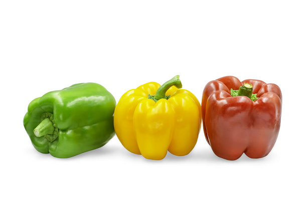 Drei Farben süßer Paprika auf weißem isoliertem Hintergrund mit Clipping-Pfad. Gelbe, grüne und rote Paprika haben einen hohen Vitamin- und Ballaststoffgehalt und sind saftig und knusprig für Salate und zum Kochen. - Foto, Bild