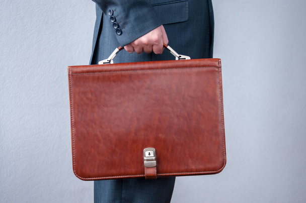 Brown briefcase in hand businessman side view - Φωτογραφία, εικόνα