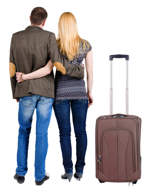 Back view of young couple traveling with suitcase. - Fotoğraf, Görsel