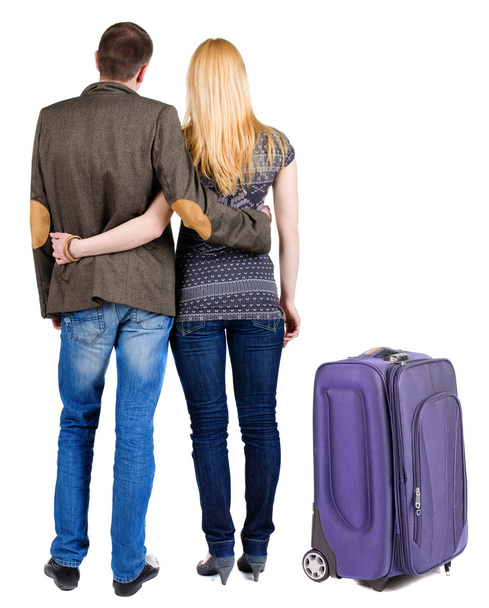 Back view of young couple traveling with suitcase. - Fotografie, Obrázek