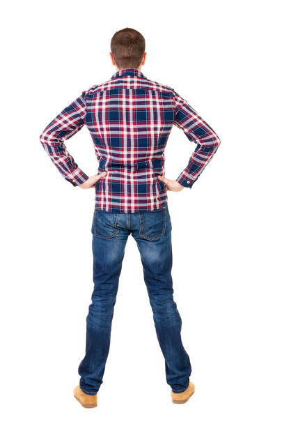 Back view of handsome man in checkered shirt looking up. - Foto, Imagen