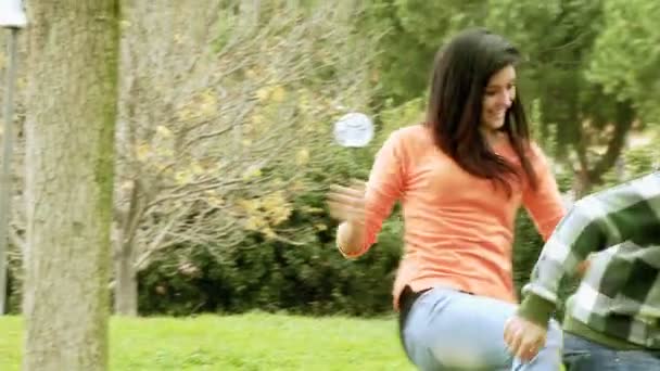 Boyfriend and girlfriend playing in park - Filmmaterial, Video