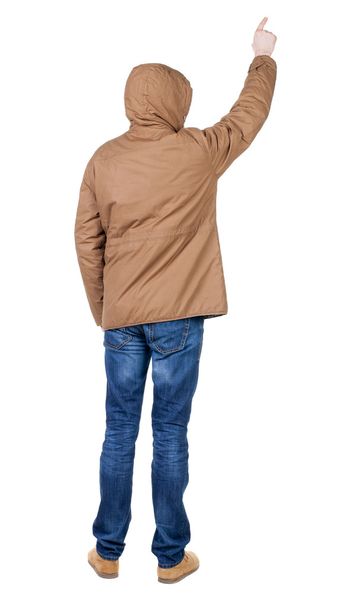 Back view of pointing young men in parka. - 写真・画像