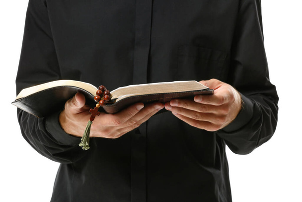 Handsome priest with Bible on white background, closeup - Photo, Image