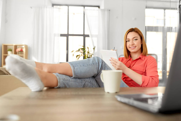 woman with notebook and laptop at home office - Photo, Image