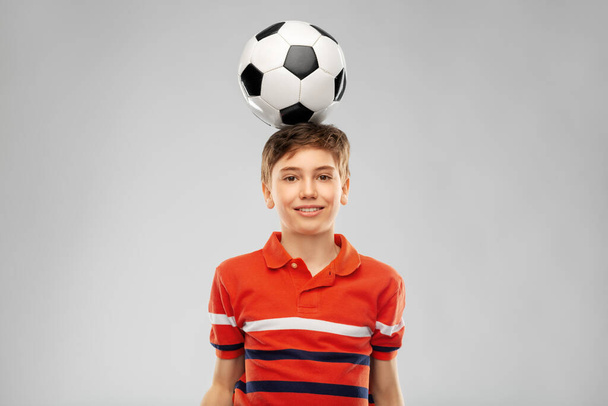 happy smiling boy with soccer ball on his head - Zdjęcie, obraz