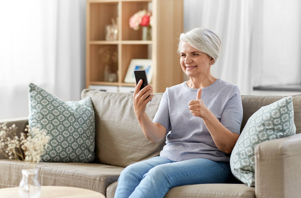 senior woman having video call on smartphone - Photo, image