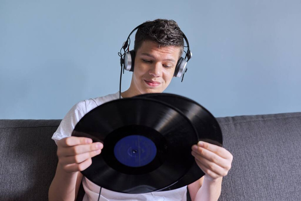 Creative teen boy with vinyl records, young man in headphones interested in music - Fotografie, Obrázek