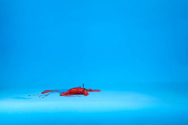 Concept photo of squashed red fresh strawberry - Fotoğraf, Görsel