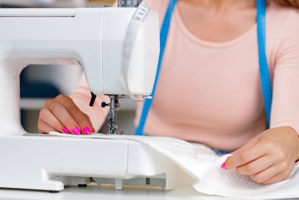 Woman seamstress working at textile factory close up - Photo, Image