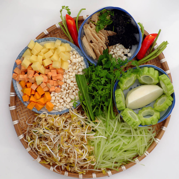 Top view tray of raw materials to cook daily meal, dieting menu from vegan food, nutrition and healthy dish from bitter melon, tofu, potato, corn, chayote and bean sprouts - Photo, Image